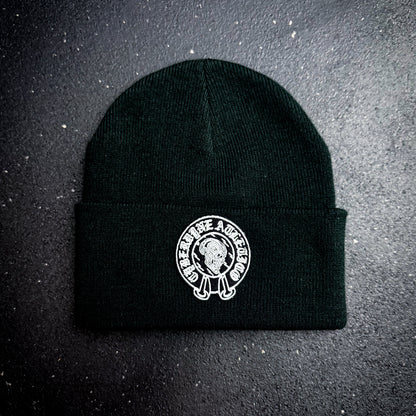 Black beanie with a white cyberdyne atletico chrome hearts style logo on a dark background