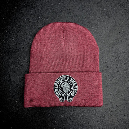 Maroon beanie with a cyberdyne atletico chrome hearts style logo on a black background