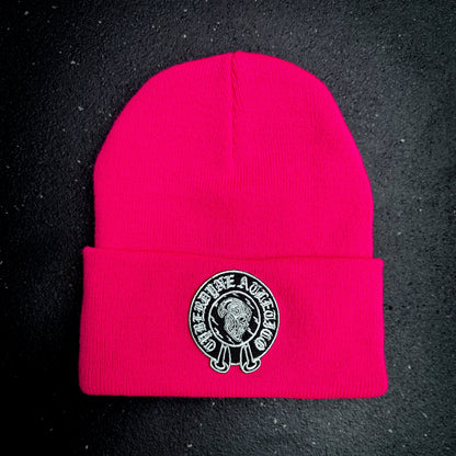Neon pink beanie with a cyberdyne atletico chrome hearts style logo on a black background